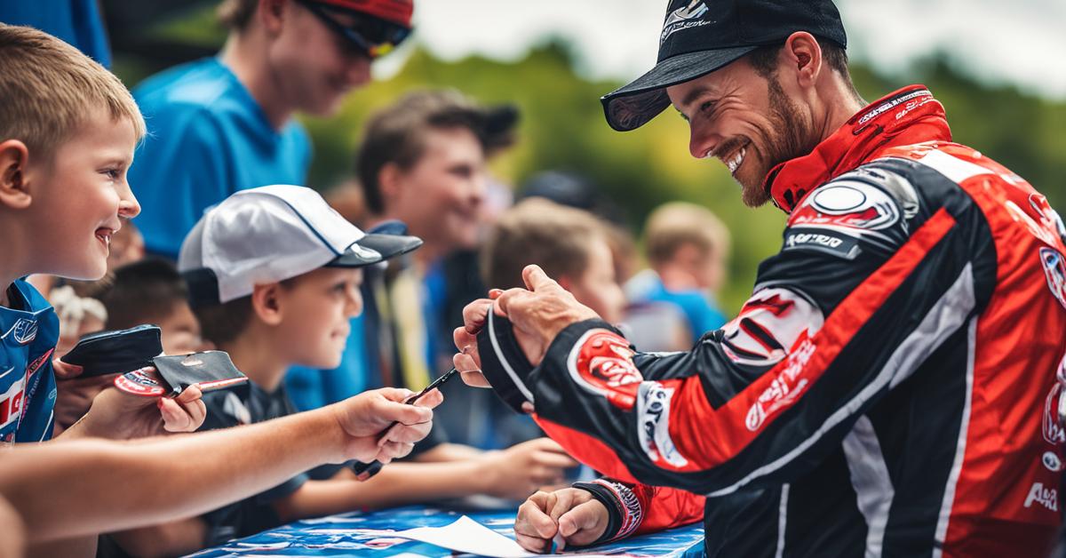 Patryk Dudek rozdaje autografy młodym kibicom.